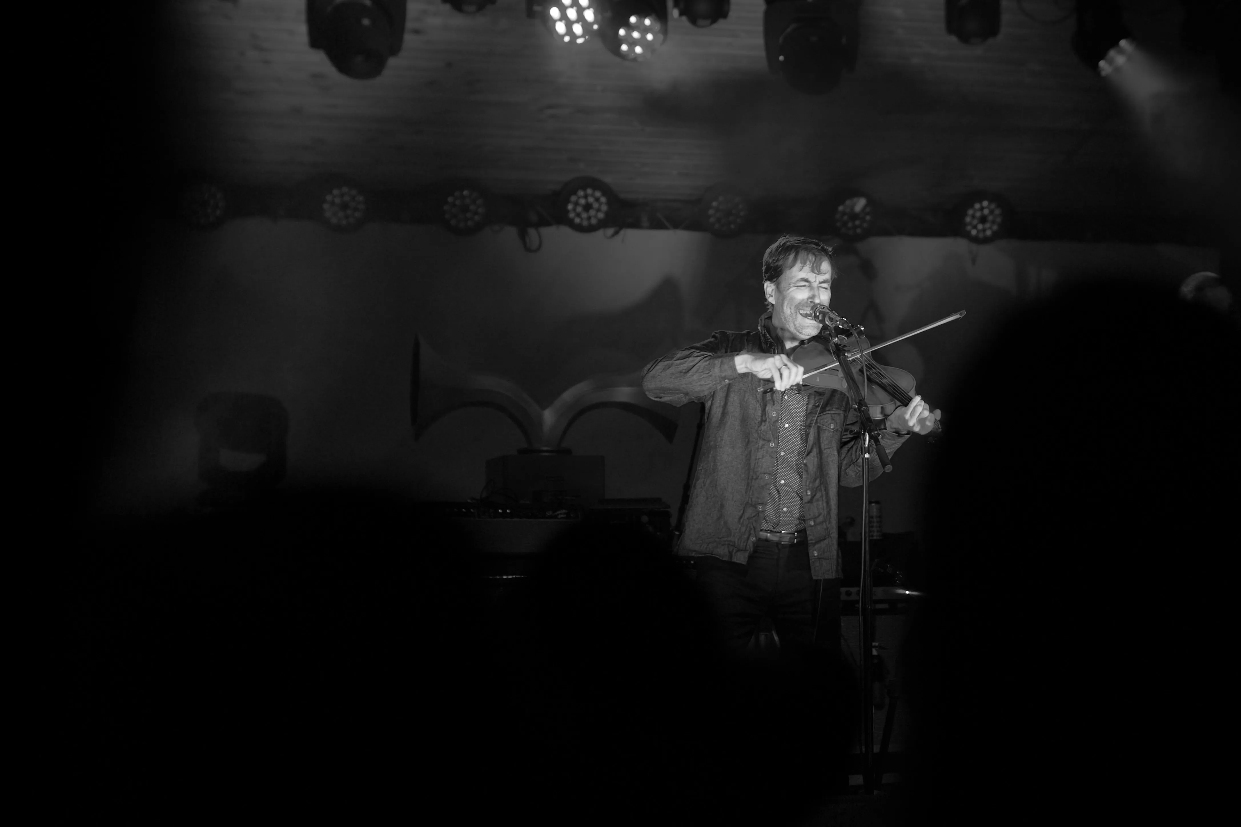 Andrew Bird playing violin and singing.