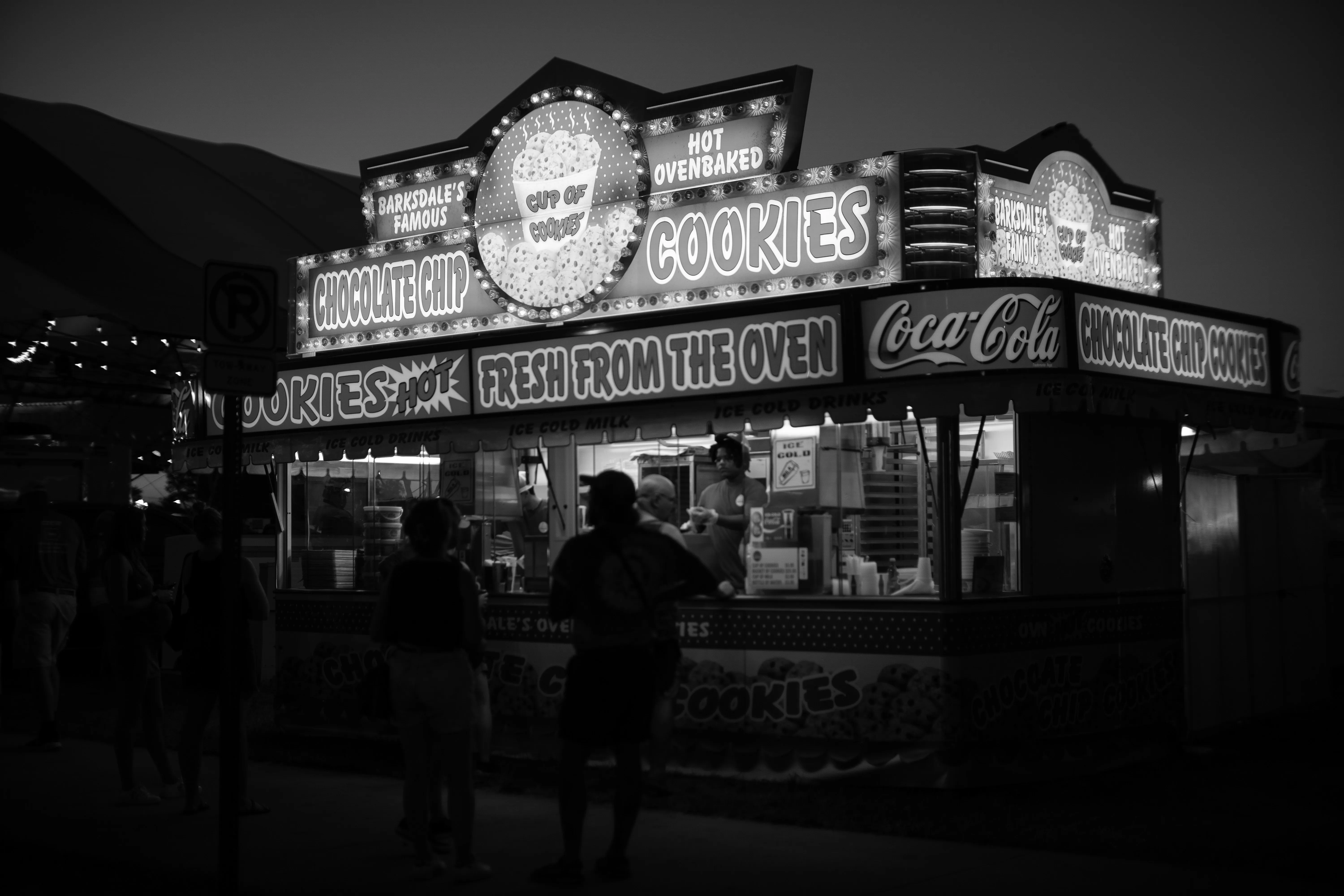 Customers standing in front of the Barksdale's Cookie stand at the Iowa State Fair.