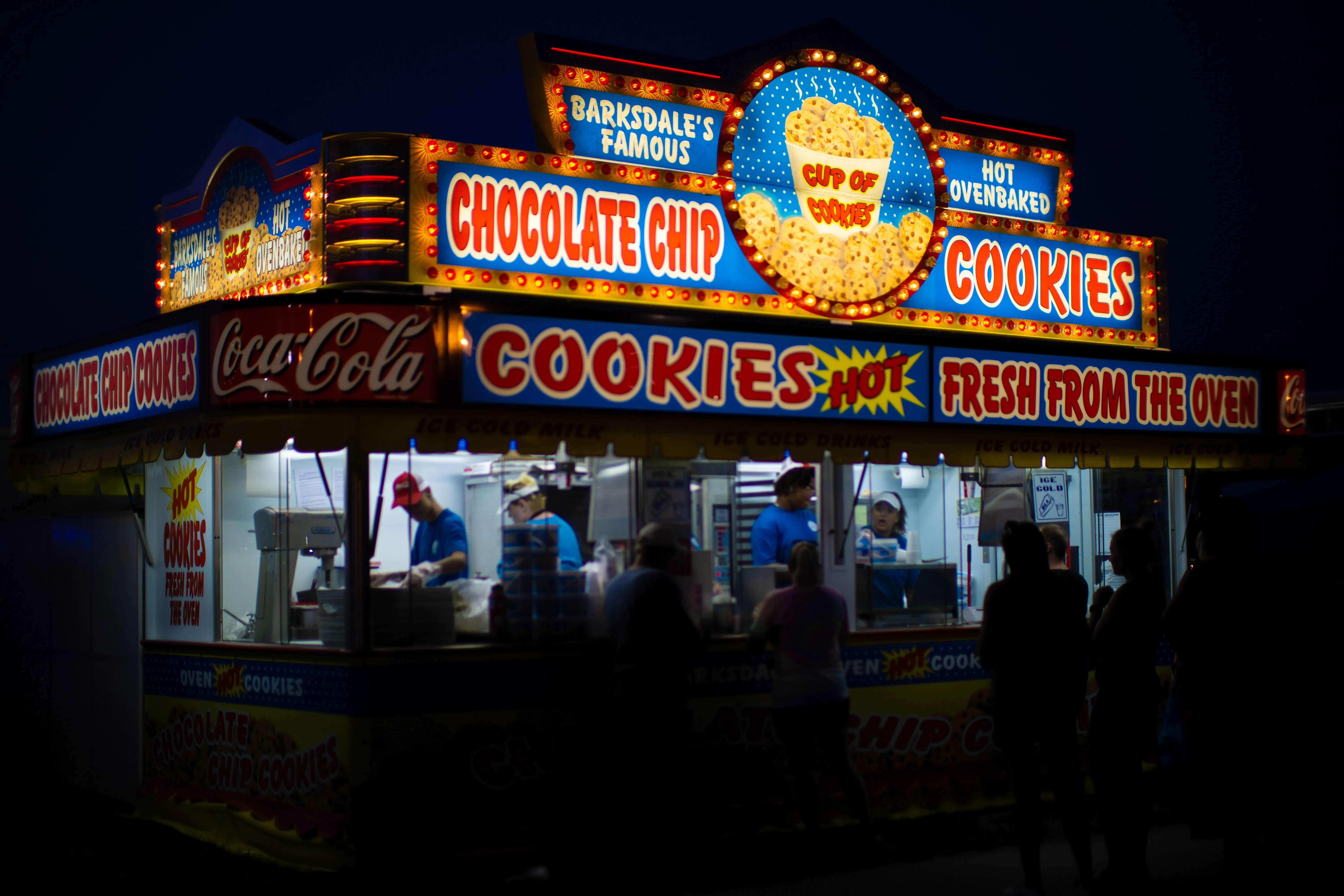 Customers standing in front of the Barksdale's Cookie stand at the Iowa State Fair.