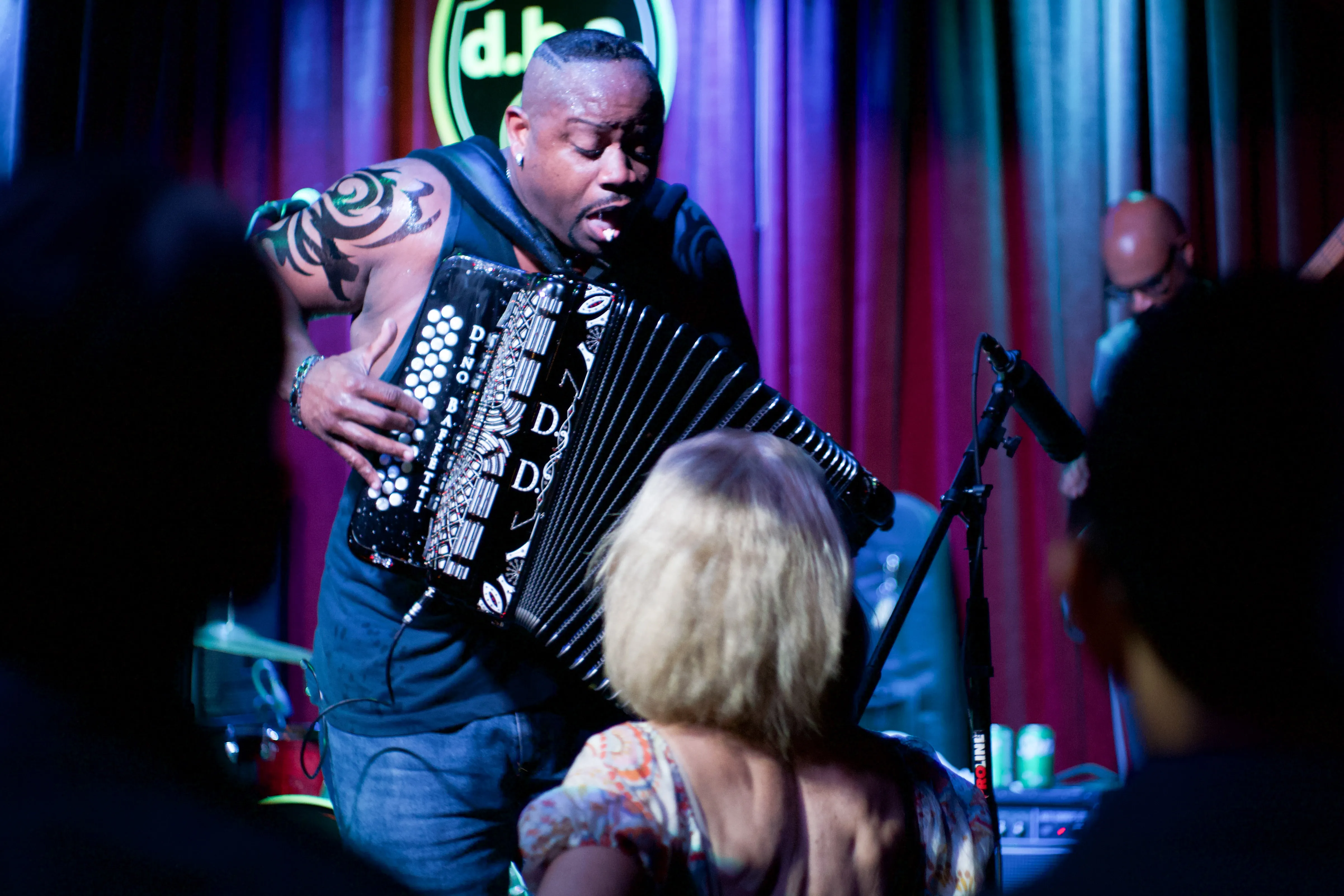 Dwayne Dopsie playing accordion on stage.