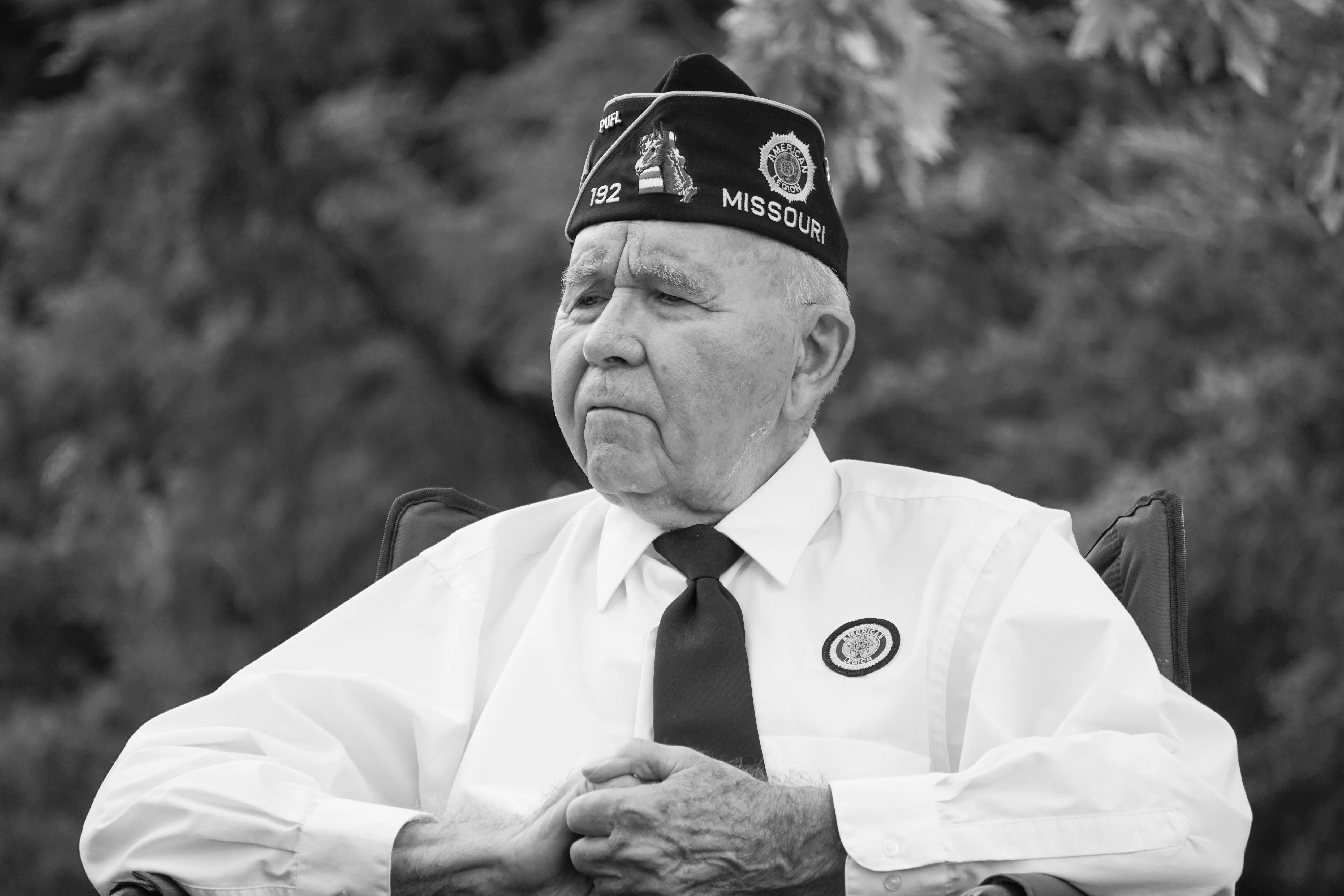 An older man in an American Legion veteran's cap.