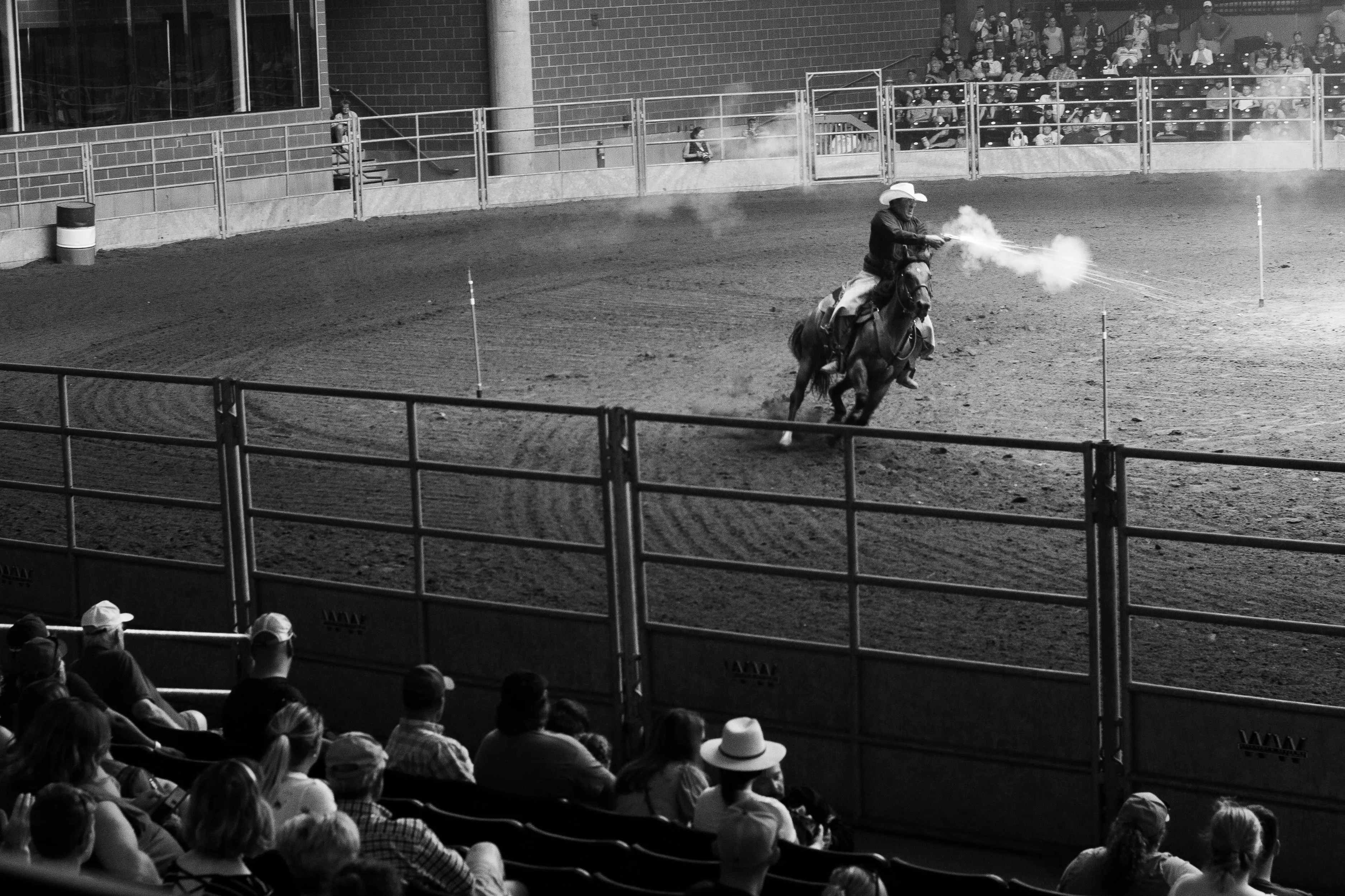 A mounted shooter shooting a balloon target.