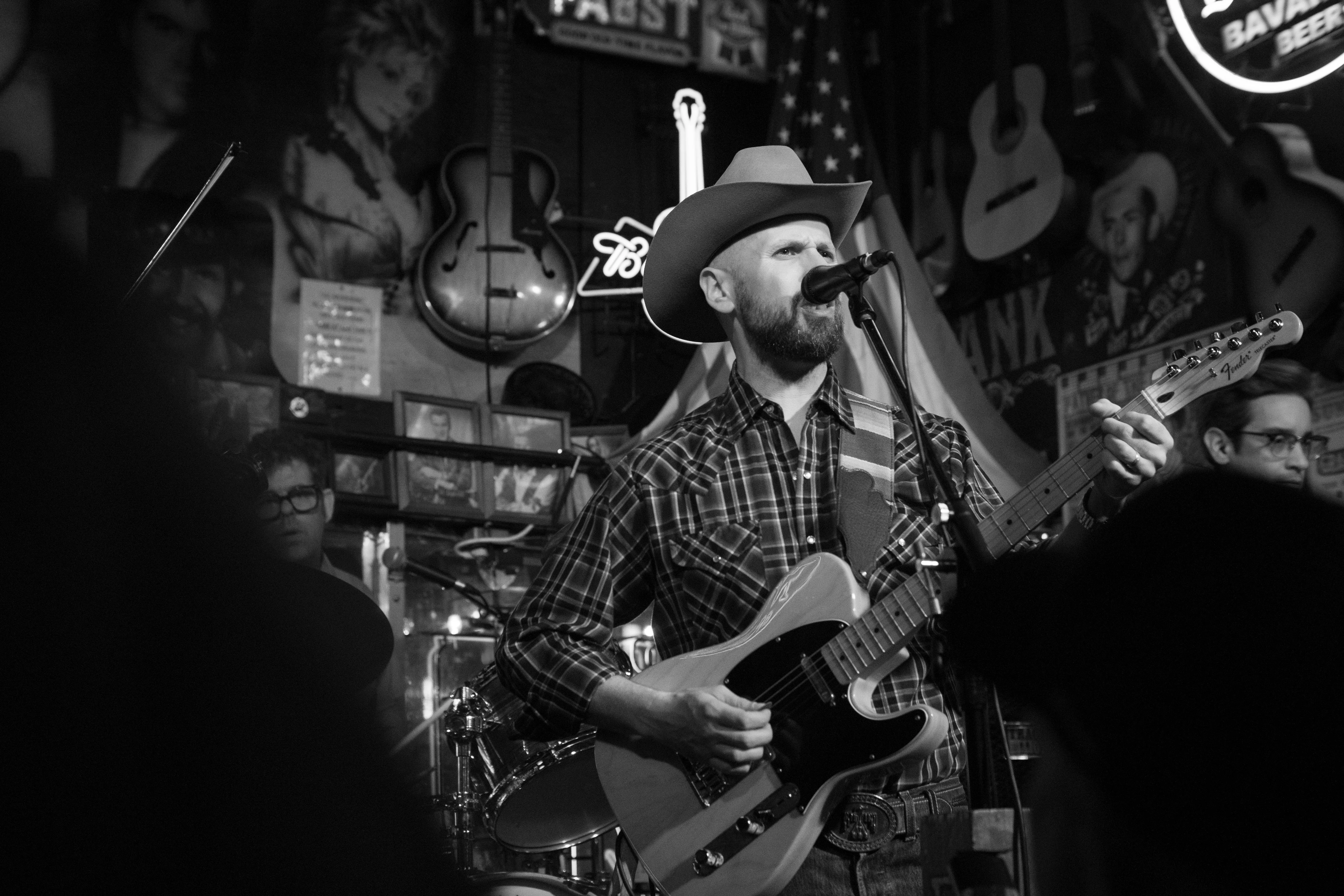 A singer in a cowboy hat on stage at Robert's Western World.