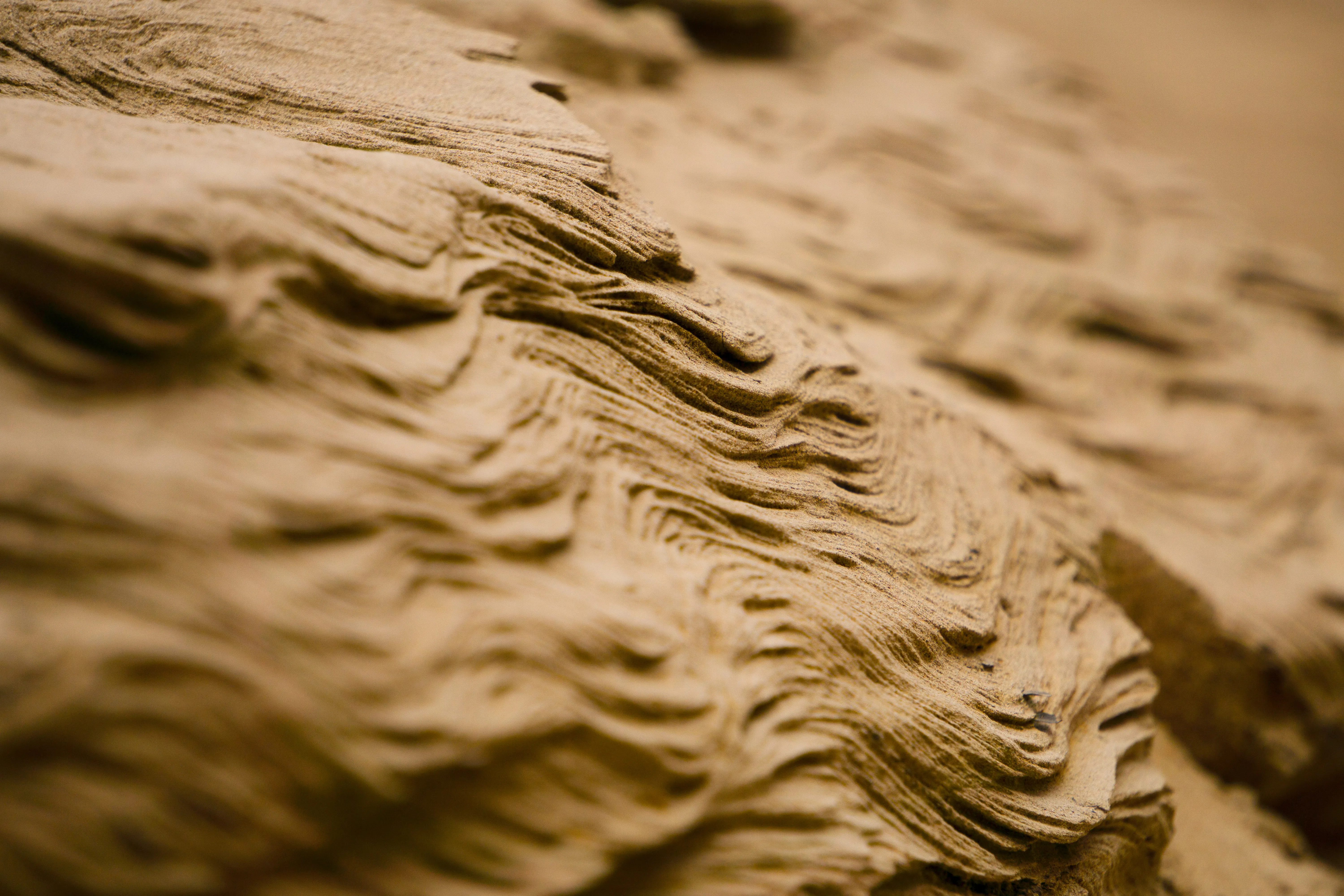 An extreme close-up of a layered sand bank.