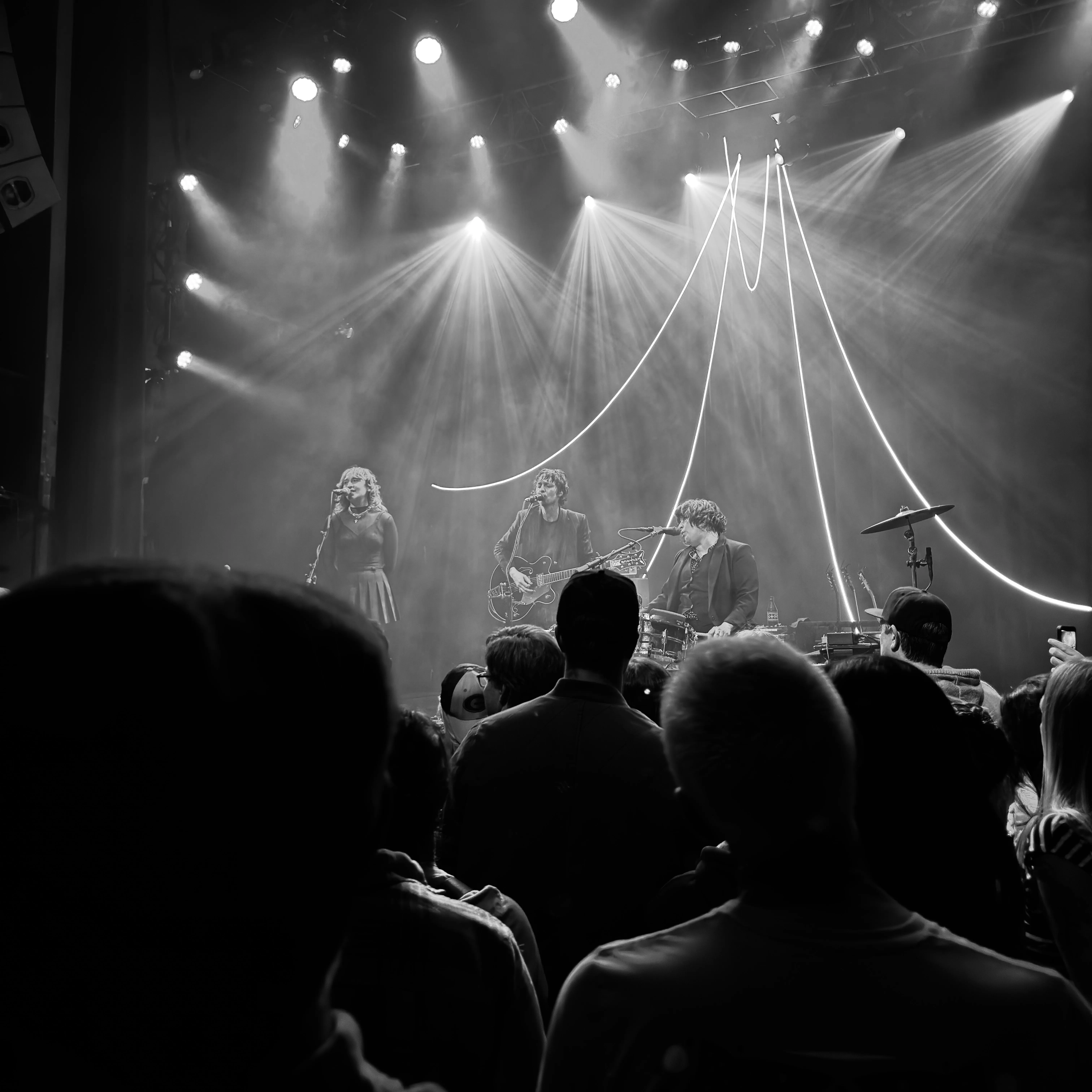 Three musicians playing on a stage.